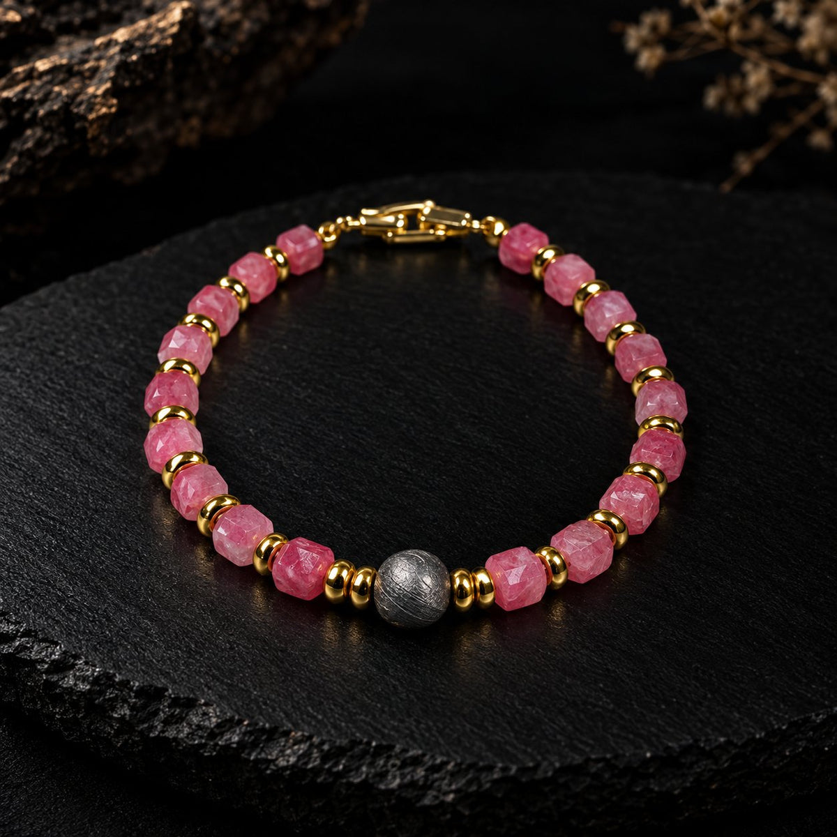 Eos · 初曦 — sugar-cube rhodochrosite beads with gold-plated spacers and an 8 mm iron meteorite center bead, photographed on dark slate