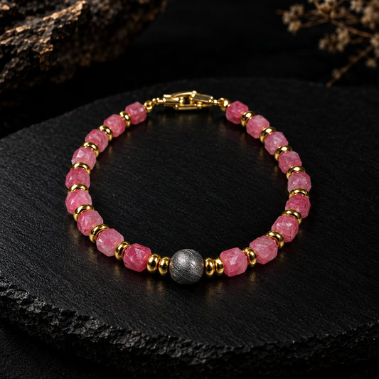 Eos · 初曦 — sugar-cube rhodochrosite beads with gold-plated spacers and an 8 mm iron meteorite center bead, photographed on dark slate